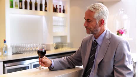 Businessman-drinking-glass-of-red-wine