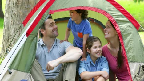 Family-posing-in-their-tent-on-a-camping-trip