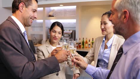 Business-associates-celebrating-after-work-and-drinking-wine