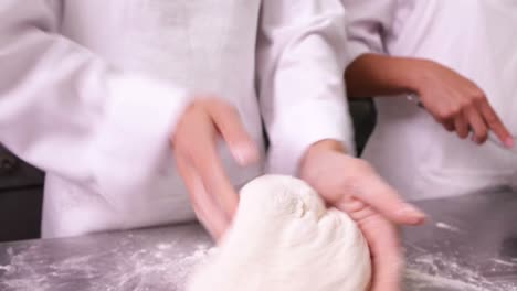Pastry-chefs-preparing-dough-at-counter