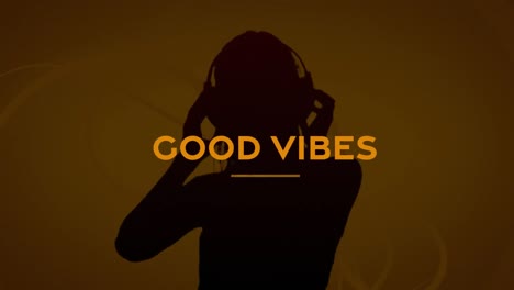 Animation-of-good-vibes-text-over-person-using-headphones