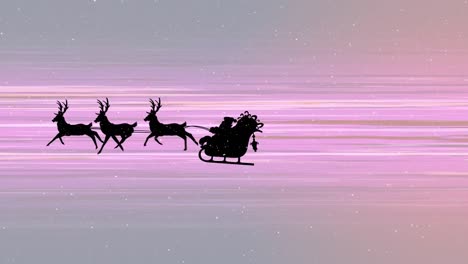 Snow-falling-over-silhouette-of-santa-claus-in-sleigh-being-pulled-by-reindeers-against-light-trails