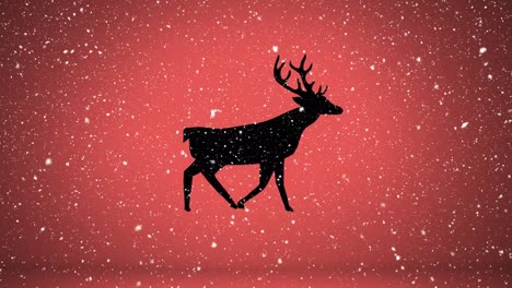 Snow-falling-over-silhouette-of-reindeer-walking-against-orange-background