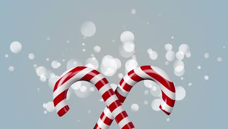 Digital-animation-of-candy-cane-icon-against-spots-of-light-on-grey-background