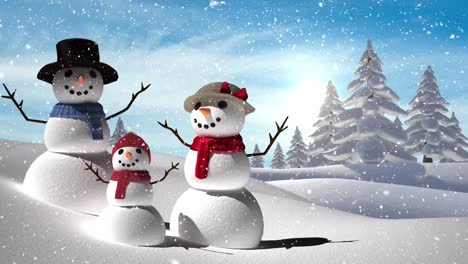 Snow-falling-over-snowman-family-on-winter-landscape-against-blue-sky