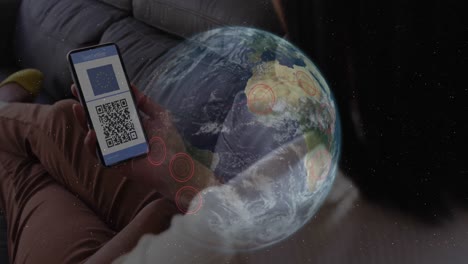 Animation-of-woman-holding-smartphone-with-covid-19-vaccination-passport-over-globescape