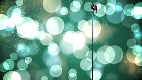 Animation-of-snow-falling-and-light-spots-over-microphone-with-santa-hat