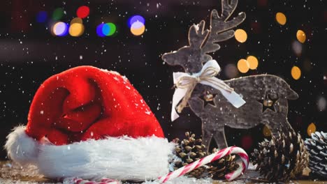 Animation-of-snow-falling-over-santa-hat,-reindeer-and-colorful-bokeh