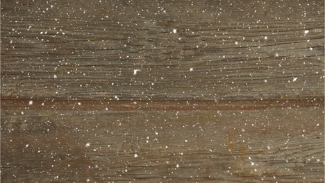 Animation-of-snow-falling-over-wood-board