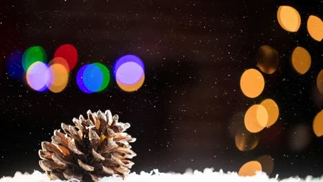 Animation-of-snow-falling-over-pine-cone-and-colorful-bokeh