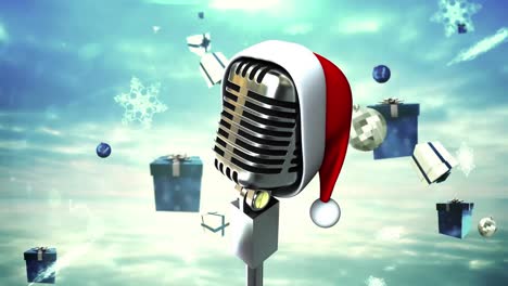 Animation-of-retro-microphone-with-santa-hat-over-falling-presents-and-snow-on-blue-background