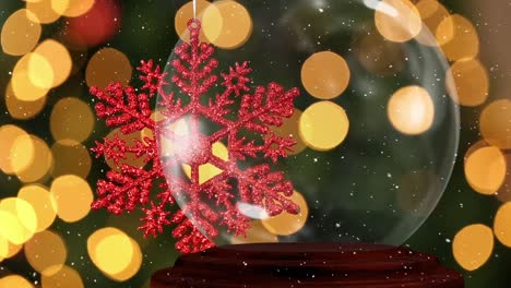 Animation-of-red-snowflake-over-snow-falling-and-bokeh