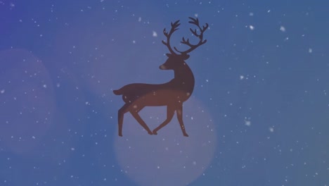 Snow-falling-and-spots-of-light-over-silhouette-of-reindeer-walking-against-blue-background