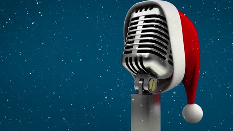 Animation-of-snow-falling-and-microphone-with-santa-hat-on-blue-background