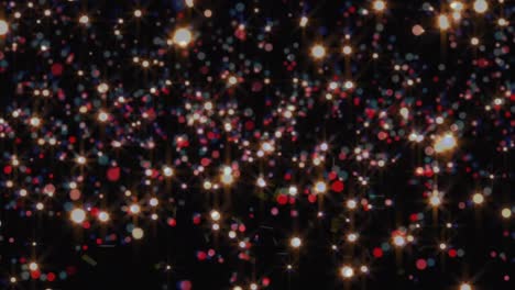 Animation-of-confetti-and-glowing-multi-coloured-spots-over-black-background