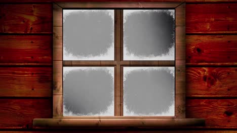 Wooden-retro-window-frame-over-snow-falling-against-black-background