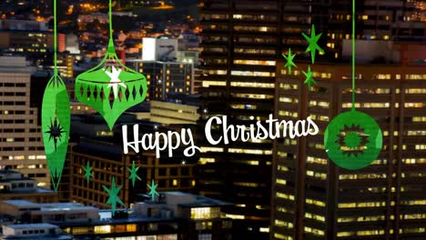 Happy-christmas-text-with-green-christmas-hanging-decorations-against-aerial-view-of-night-cityscape