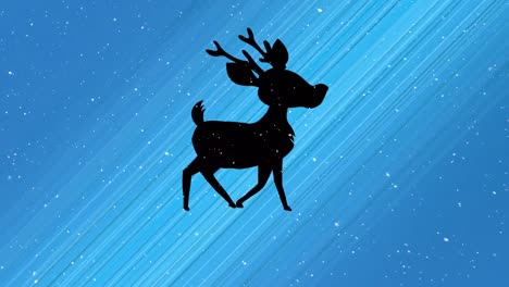 Snow-falling-over-silhouette-of-reindeer-walking-against-light-trails-on-blue-background