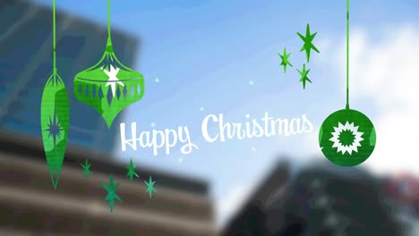 Happy-christmas-text-with-green-christmas-hanging-decorations-against-tall-buildings-in-background