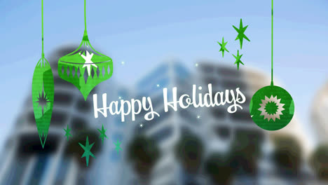 Happy-holidays-text-with-green-christmas-hanging-decorations-against-tall-buildings-in-background