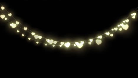 Digital-animation-of-decorative-heart-shaped-fairy-lights-hanging-against-black-background