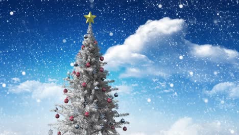 Snow-falling-over-christmas-tree-against-clouds-in-the-blue-sky