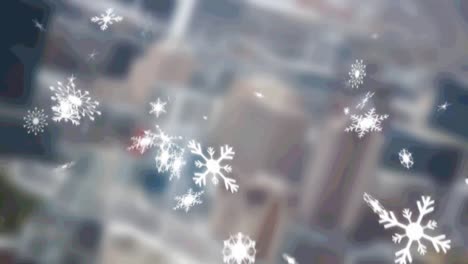 Multiple-snowflakes-icons-falling-against-aerial-view-of-blurred-cityscape