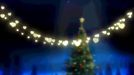 Animation-of-glowing-fairy-lights-over-christams-tree-and-winter-landscape