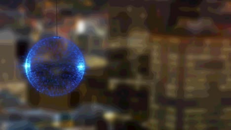 Animation-of-blue-glowing-bauble-over-blurred-cityscape