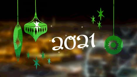 Animation-of-2021-text-and-christmas-decoration-over-blurred-cityscape