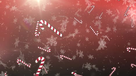 Snowflakes-and-multiple-candy-cane-icons-falling-against-spot-of-light-on-red-background