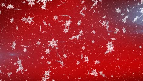 Snow-falling-and-snowflakes-icons-against-spot-of-light-on-red-background