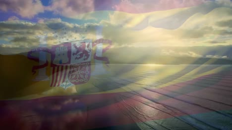 Animation-Der-Flagge-Spaniens,-Die-über-Der-Strandlandschaft-Und-Dem-Wolkenverhangenen-Blauen-Himmel-Weht