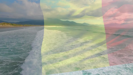 Animation-Der-Belgischen-Flagge,-Die-über-Der-Strandlandschaft,-Dem-Meer-Und-Dem-Wolkenverhangenen-Blauen-Himmel-Weht