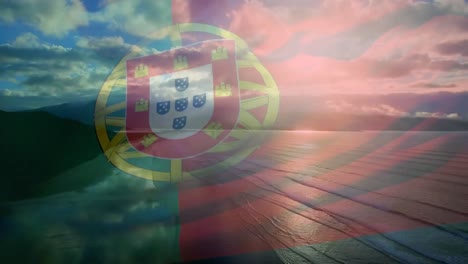 Digital-composition-of-waving-portugal-flag-against-aerial-view-of-the-beach-and-sea-waves