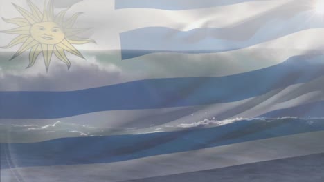 Digital-composition-of-waving-uruguay-flag-against-aerial-view-of-waves-in-the-sea