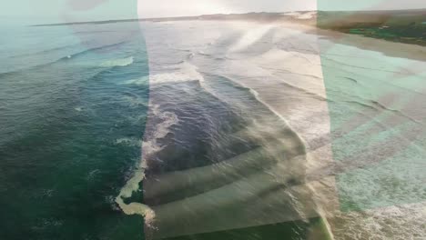Digitale-Komposition-Der-Wehenden-Nigeria-Flagge-Vor-Der-Luftaufnahme-Des-Strandes-Und-Der-Meereswellen