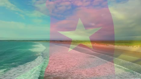 Digital-composition-of-waving-cameroon-flag-against-aerial-view-of-beach-and-sea-waves