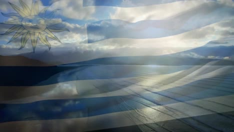 Digitale-Komposition-Der-Wehenden-Uruguay-Flagge-Vor-Der-Luftaufnahme-Des-Strandes-Und-Des-Meeres