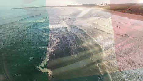 Animation-of-flag-of-italy-blowing-over-beach-landscape