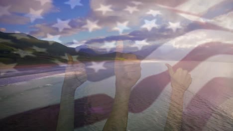 Animation-Der-Flagge-Der-USA,-Die-Mit-Einer-Geste-über-Der-Strandlandschaft-über-Die-Hände-Weht