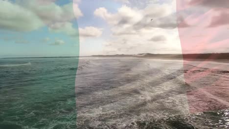 Animation-of-flag-of-italy-blowing-over-okay-hands-on-beach-landscape