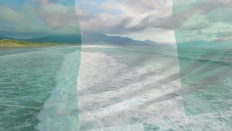 Digitale-Komposition-Der-Nigerianischen-Flagge,-Die-Vor-Der-Luftaufnahme-Der-Wellen-Im-Meer-Weht