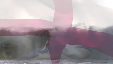 Digital-composition-of-england-flag-waving-against-aerial-view-of-waves-in-the-sea