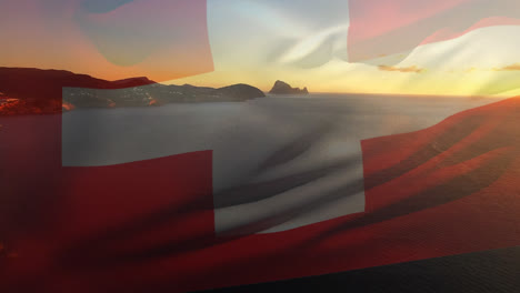 Digitale-Komposition-Der-Schweizer-Flagge,-Die-Vor-Der-Luftaufnahme-Der-Wellen-Im-Meer-Weht