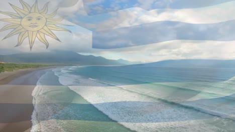 Digital-composition-of-waving-uruguay-flag-against-aerial-view-of-beach-and-sea-waves
