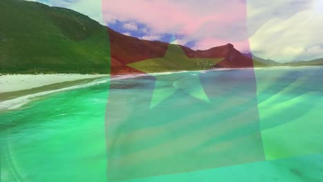 Digitale-Komposition-Der-Kamerunischen-Flagge,-Die-Vor-Der-Luftaufnahme-Der-Wellen-Im-Meer-Weht