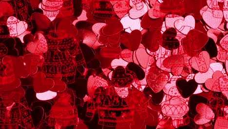 Animation-of-christmas-jumpers-over-glowing-pink-hearts