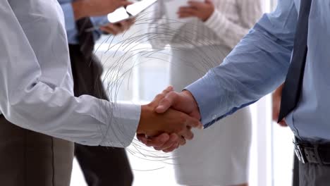 Animation-of-spinning-connections-over-businessman-handshake