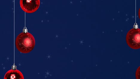 Animation-of-snow-falling-over-christmas-bauble-decorations-on-navy-background